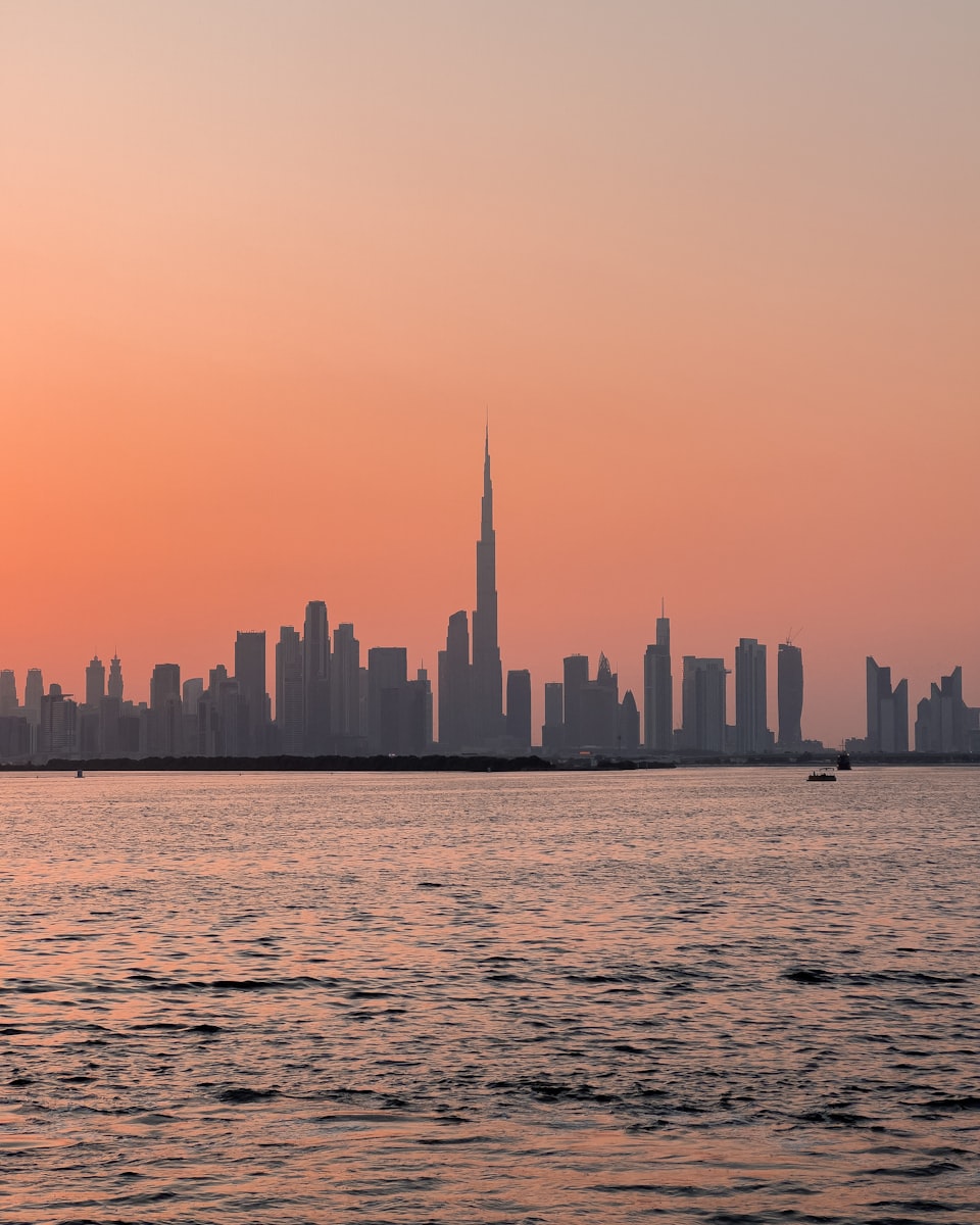 Burj Khalifa rising above Dubai's waterfront at sunset